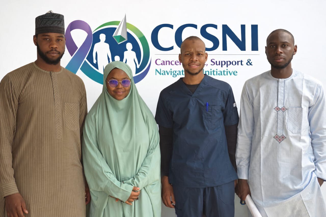 Diverse Nigerian community members in cancer awareness and support event, united in hope and compassion